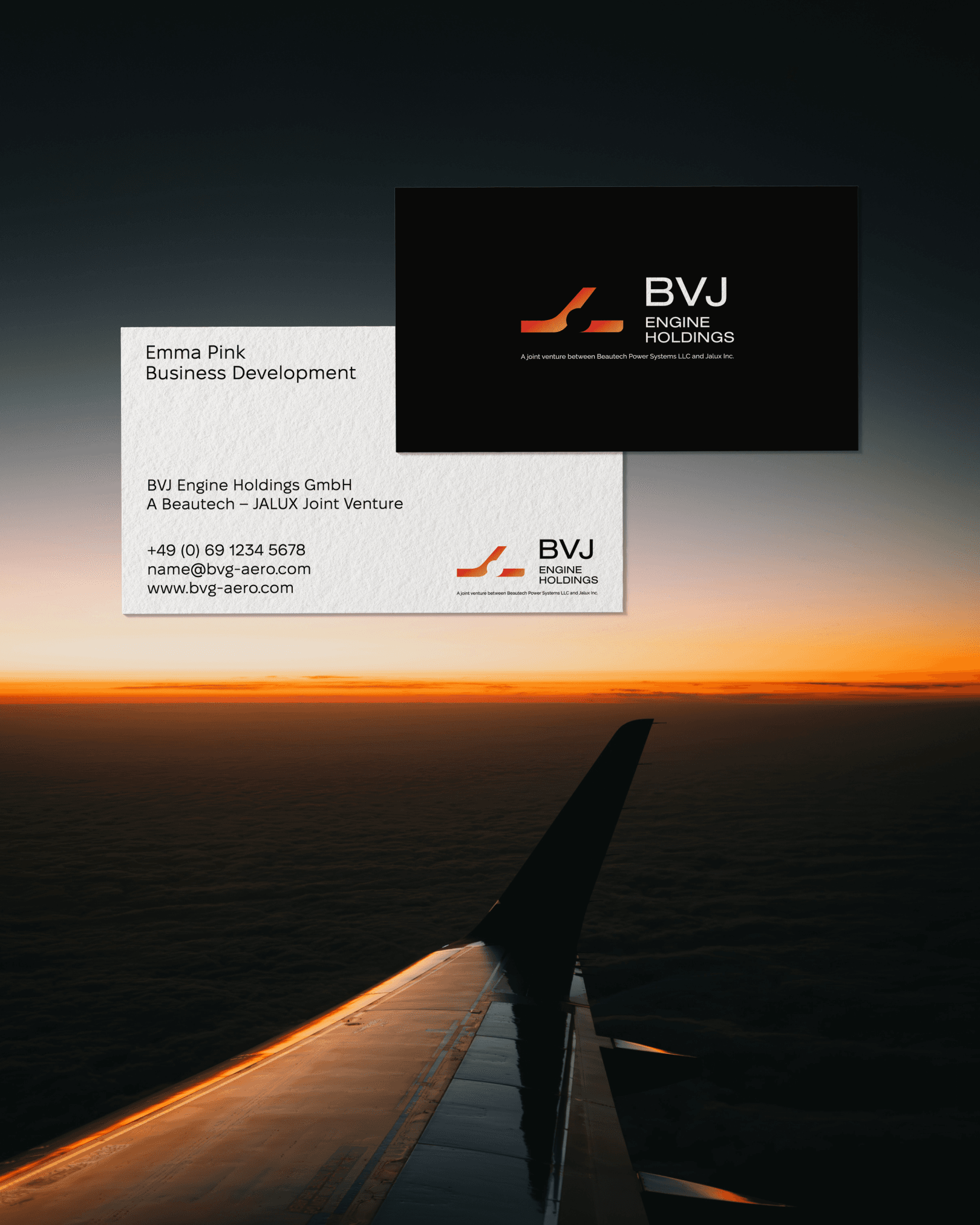 BVJ Engine Holdings business cards over an airplane wing at dusk