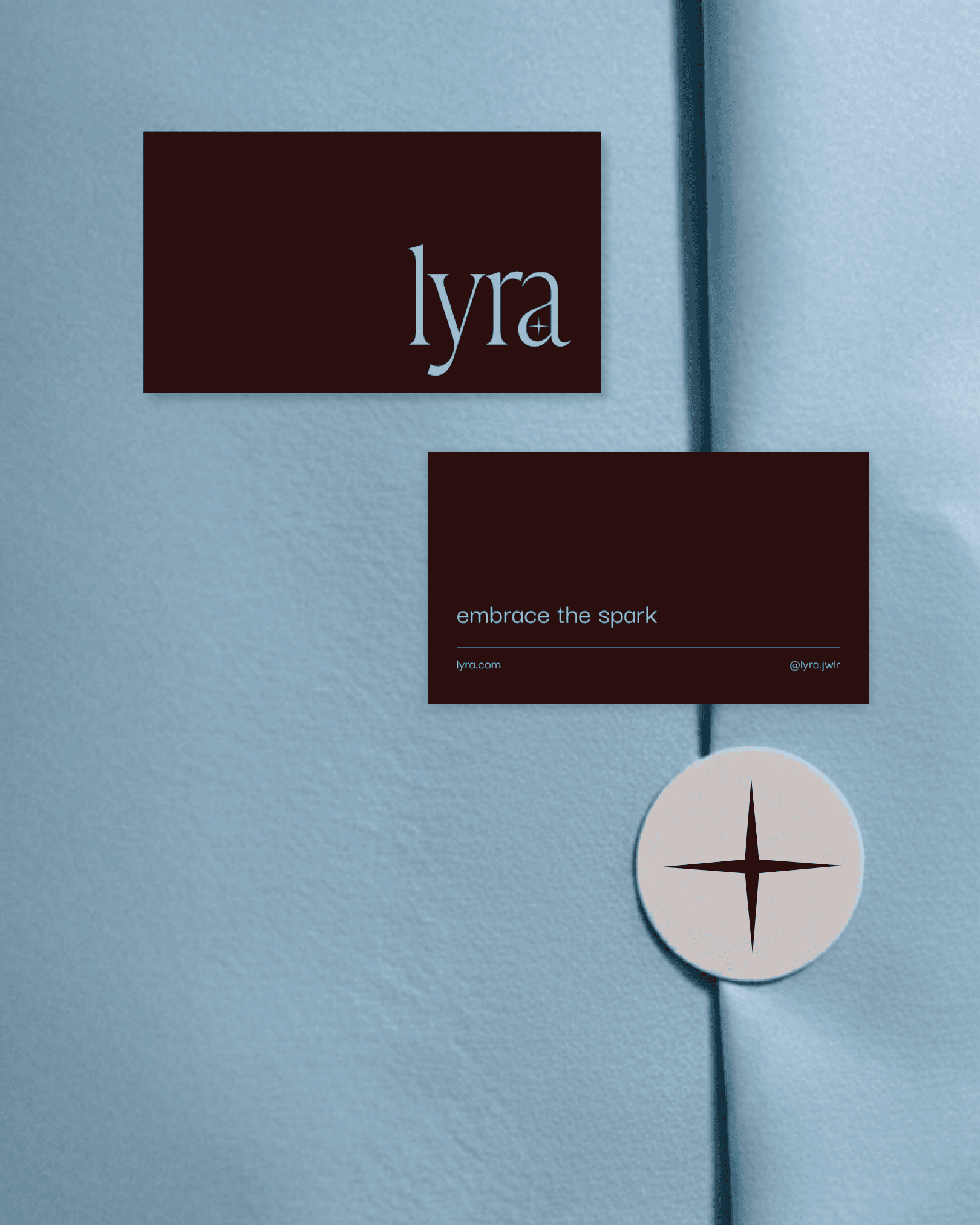Lyra burgundy business cards and star seal on blue paper